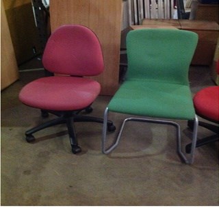 Mixed office chairs varied colours and sizes.
