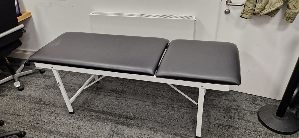 Adjustable, reclining First aid bed. Barely used.