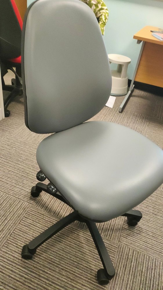 Grey vinyl chair on carpet castors 