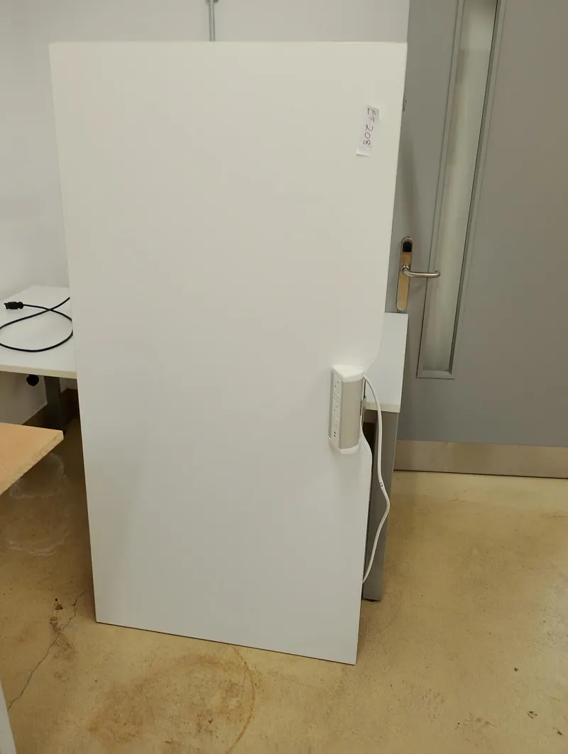 Large white office desk with desk socket.