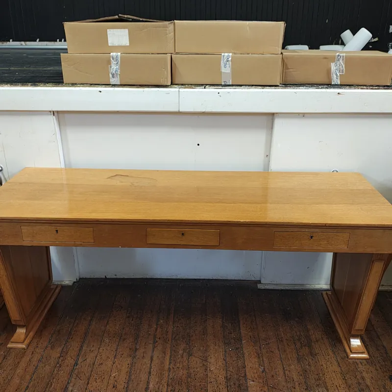 Large wooden desk with three drawers