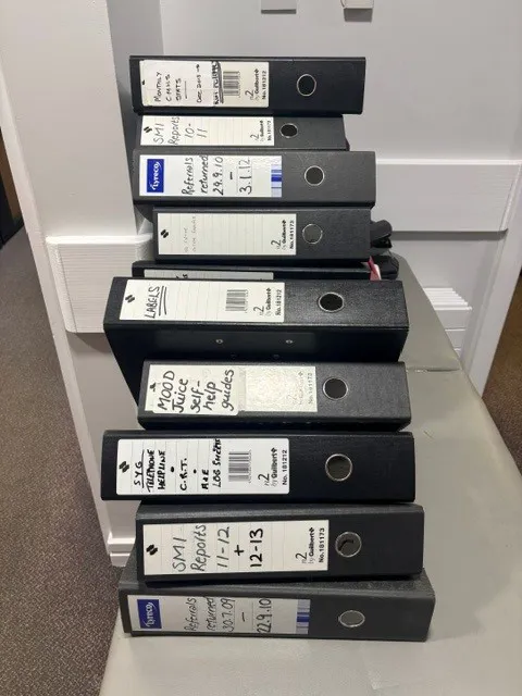 Stack of 9 Black Lever Arch Files with Labels