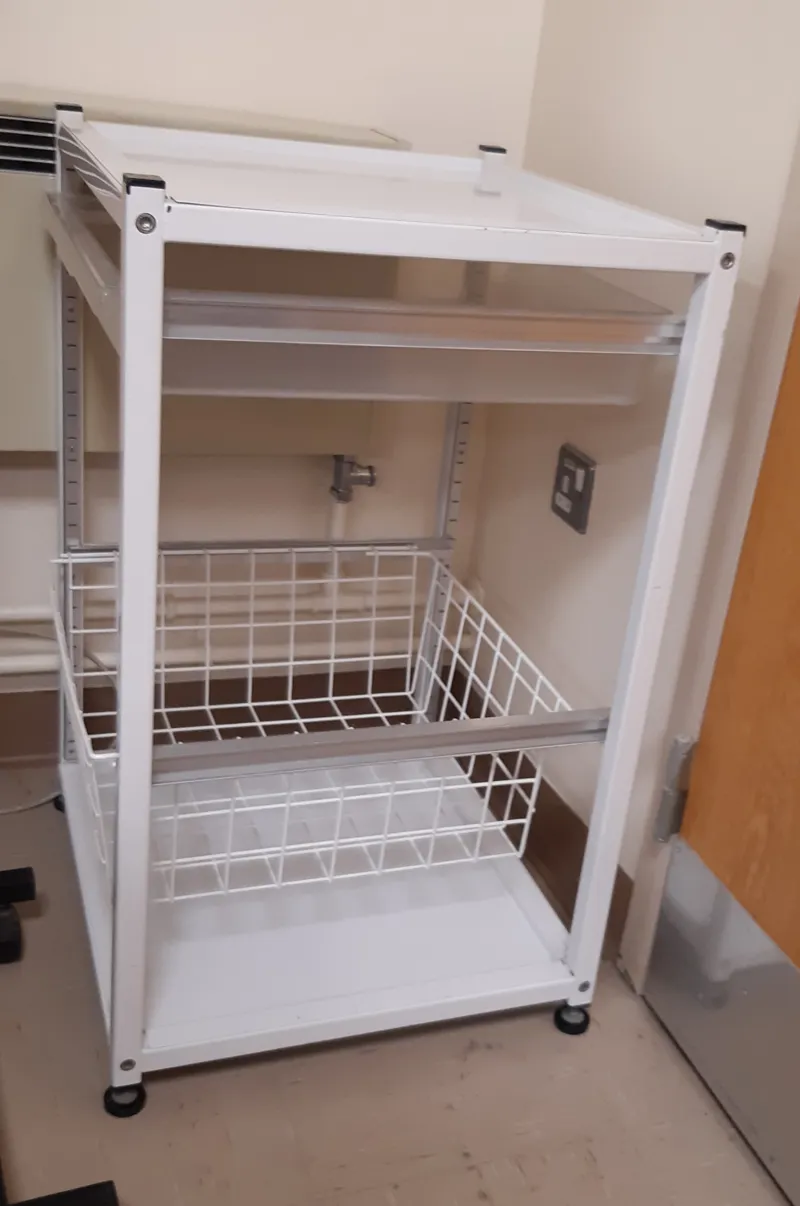 Storage with plastic drawer and wire basket, static, does not have castors/wheels.